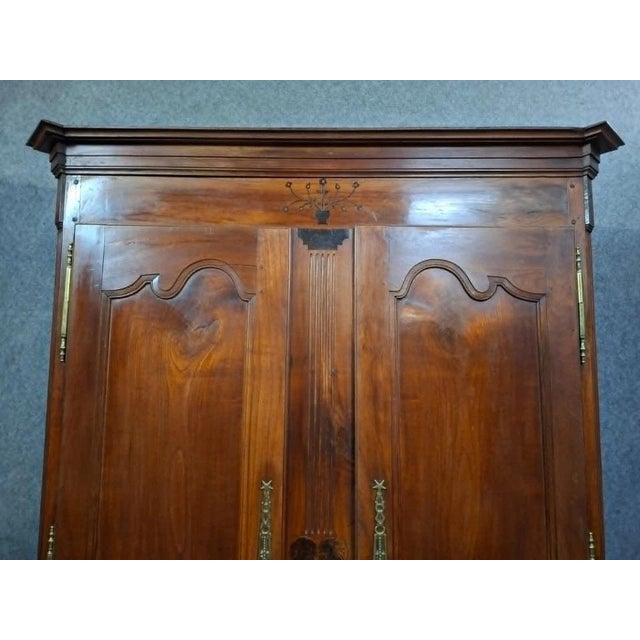 Beautiful Louis XV period regional wardrobe in solid walnut. Opening with two molded doors on the front, it rests on...