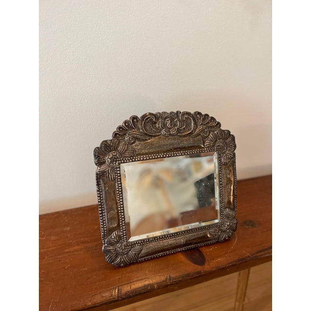 Charming antiqued mirror with Pewter framing with the sweetest floral details. This is a versatile mirror where you can...