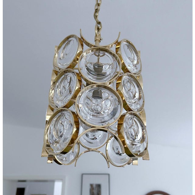 Mid century pendant light by palwa, faturing rows of round cabochon style crystals mounted on a gilded arches structure...