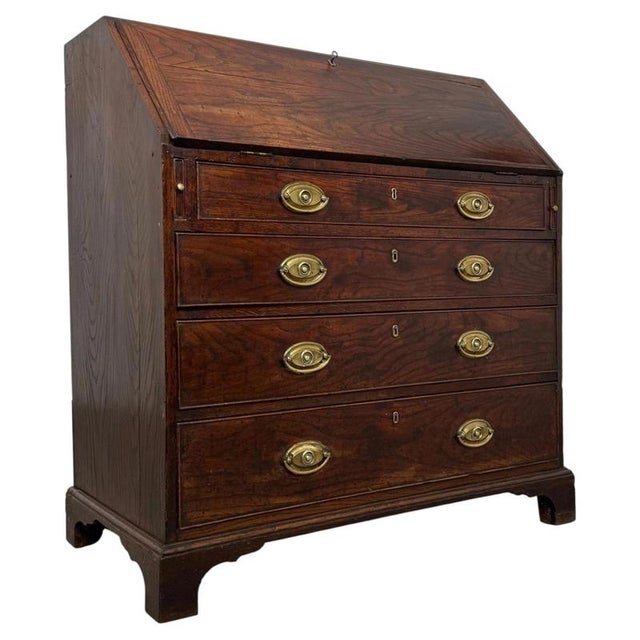 A handsome 18th century English Georgian bureau, finely constructed in oak and combining an elegant fall-front writing...