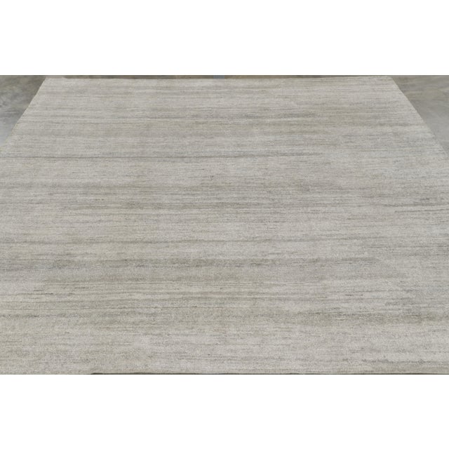 Hand-knotted in a luxurious blend of all-natural silk, this square 8x8 textural rug is an exciting new addition to the...