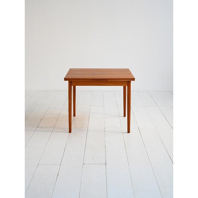 Scandinavian-style 1960s teak veneer table with pull-out extension. Extendable Scandinavian-style dining table, crafted in...