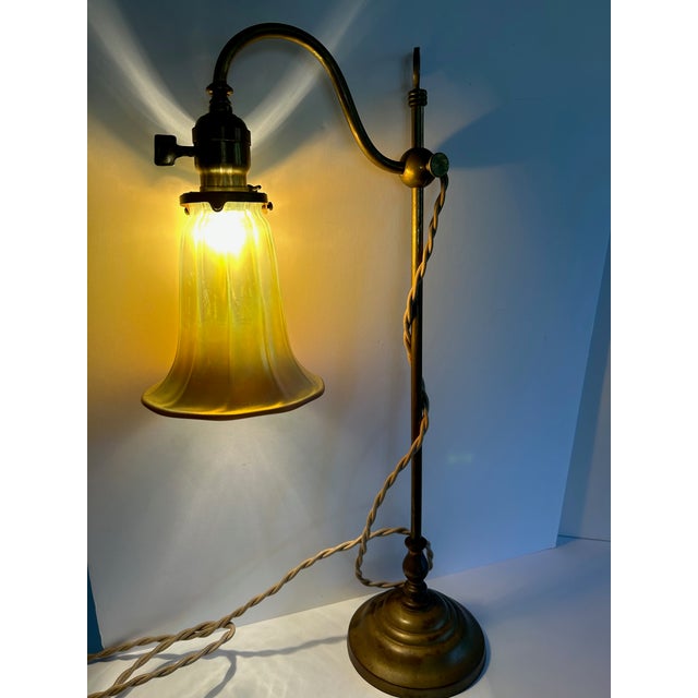 Antique Adjustable Brass Table Lamp With Tiffany Style Shade. Originally from France around the 1930's this lamp was...