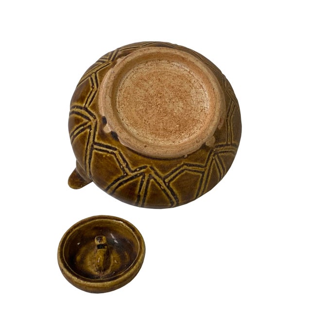 This is a handmade Chinese accent decorative art made of ceramic in brown beige tan mix color with simple woven lines...