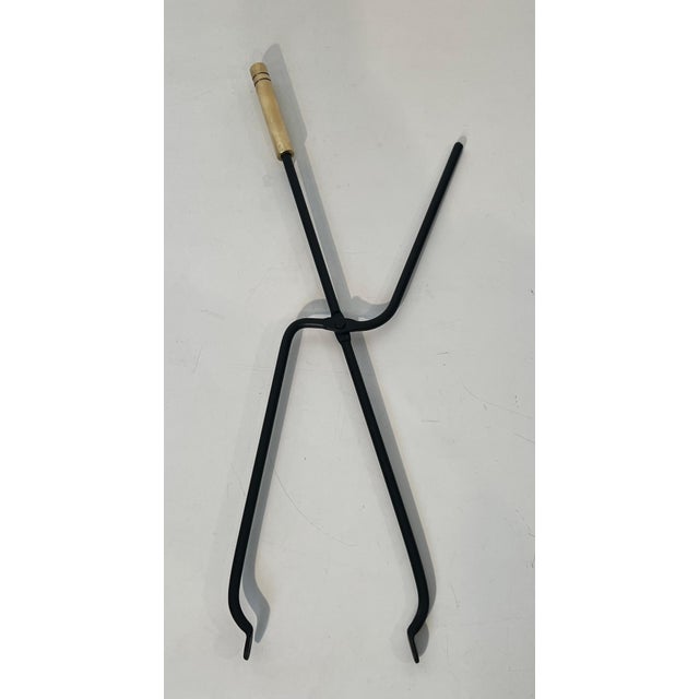 This beautiful designer fireplace tool on a base is made of black lacquered metal and brass. This is a French work. Circa...