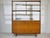 Mid-century teak highboard with an open shelving unit, 1960s. The lower section offers storage behind two sliding doors...