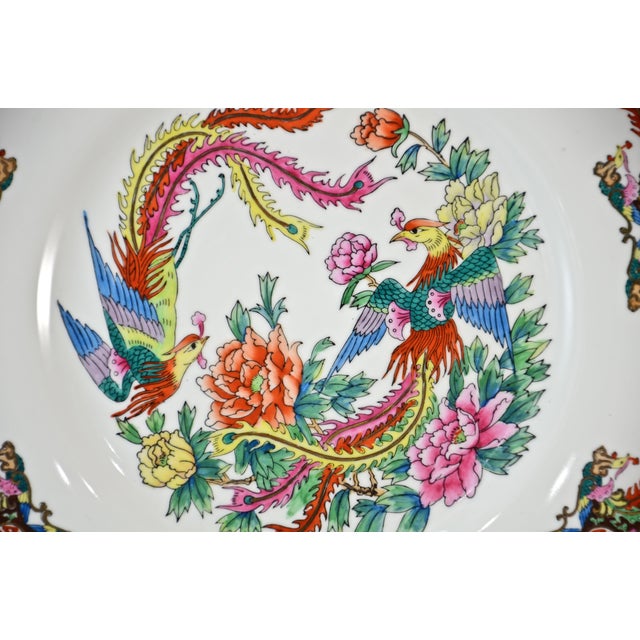 Vintage Chinese porcelain plate pattern of beautiful phoenix birds, flowers, and longevity symbols in vibrant aqua, teal,...
