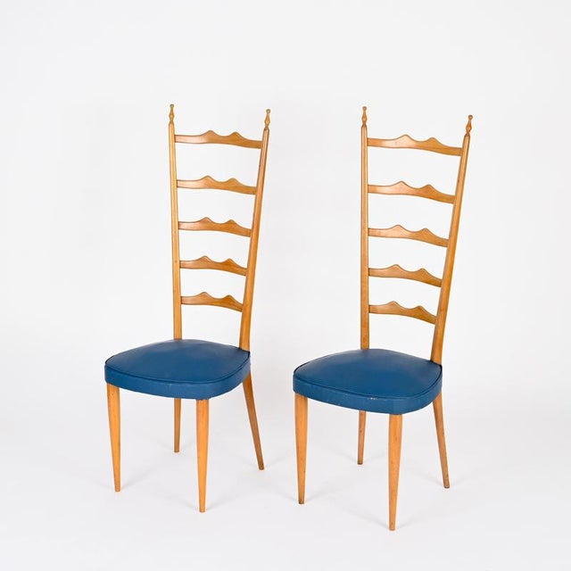 Woderful pair of high back Chiavari chairs made in a charming blonde beech wood with blue faux leather sear. These elegant...
