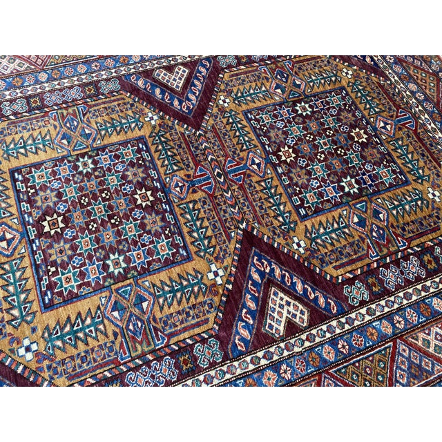 Hand-knotted wool rug from Afghanistan, woven in the Lori Pambak Kazak design — a 19th-century Caucasian pattern featuring...