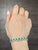 This stunning bracelet is a harmonious blend of elegance and craftsmanship. Featuring 9.45 carats of 22 oval-cut green...