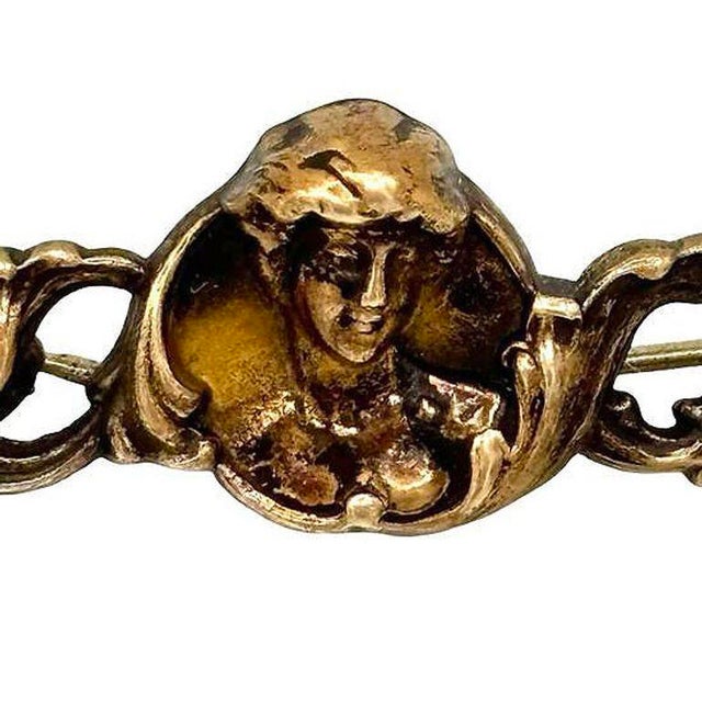 Art Nouveau Brass pin and pendant showcase a female cameo of a celestial nymph. The intricate design features delicate...