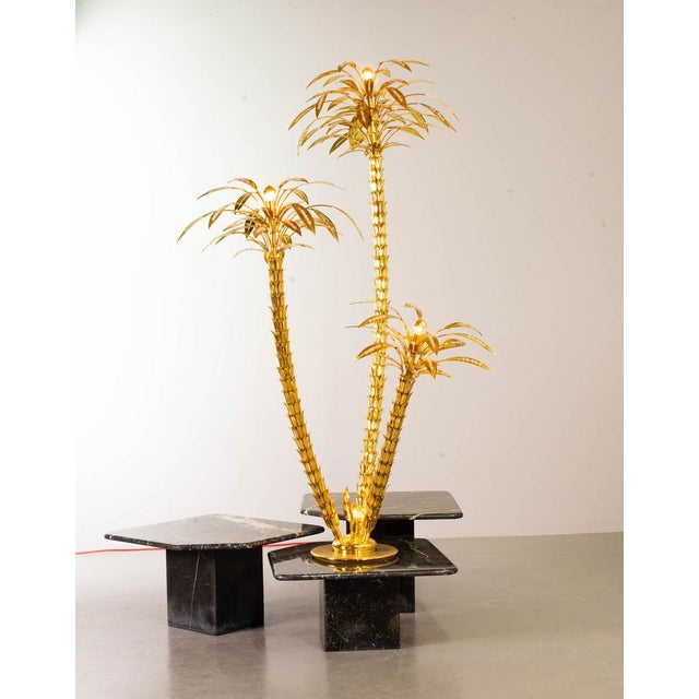 Highly decorative and rare golden palm tree floor lamp. This authentic tall lighting object features three brass branches...