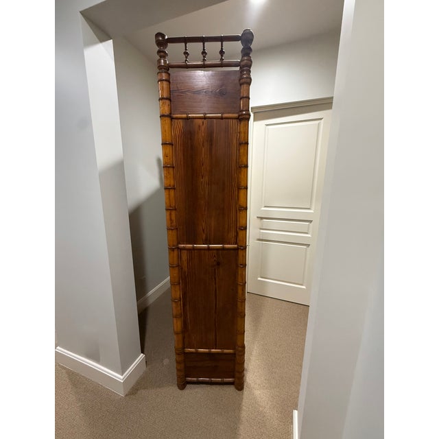 A true statement piece, this 19th-century French faux-bamboo armoire pairs sculptural detail with functional mirrored...