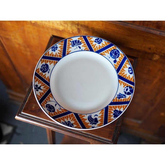 Earthenware cake stand / cake displayer with stylised orange and blue flower, cloud and fire pattern This plate has...