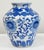Vintage Asian porcelain jar with vibrant blue and white floral motif throughout. Age wear. No chips or cracks.