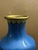 A vintage Chinese cloisonné vase handcrafted over a brass body with a vibrant cobalt blue ground featuring a delicate...