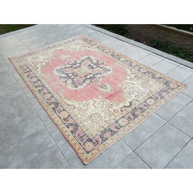 This is a vintage Turkish Oushak rug from the 1960s. The piece was hand-knotted