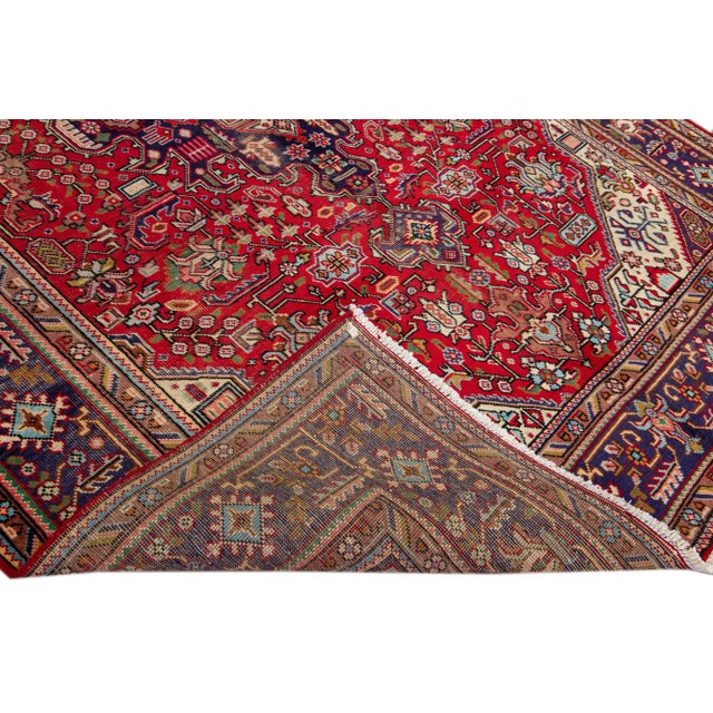 Beautiful Vintage Persian hand-knotted Wool rug with the red field. This Persian rug has a multicolor accents in all over...