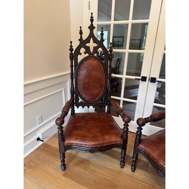 Offered is a striking and exceptionally substantial matched pair of 19th-century Victorian Gothic Revival armchairs,...