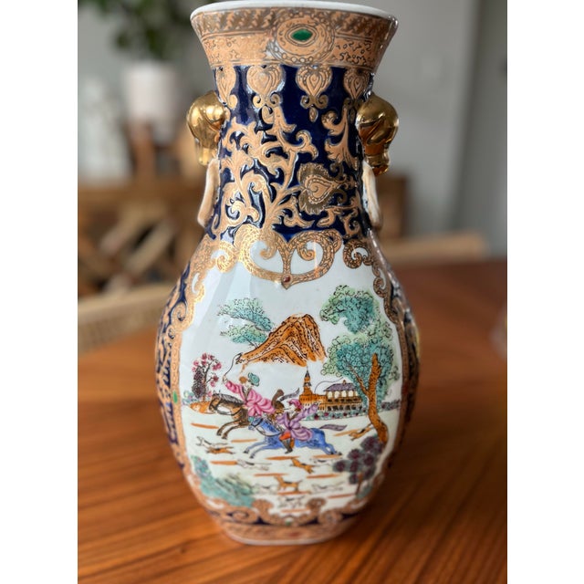 A stunning, hand-painted, decorative porcelain vase for your table or mantle decorated in an equestrian style hunting...
