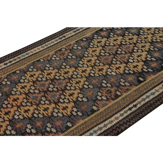 Handwoven in wool circa 1950-1960, this 3x10 vintage Kilim runner rug is a new curation from Rug & Kilim’s primitivist...
