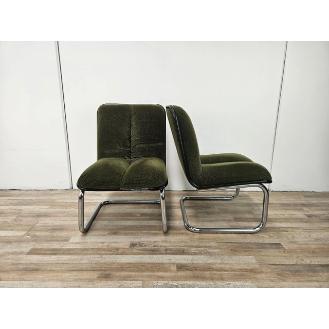 A pair of 1970s office chairs or armchairs by Cazzaro Italy. They feature a chromed tubular metal frame and a single seat...