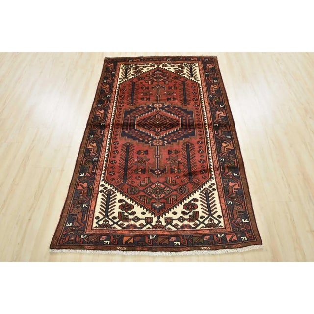 An authentic vintage tribal Zanjan rug hand-knotted with fine wool and natural dyes. This nomadic oriental rug features a...