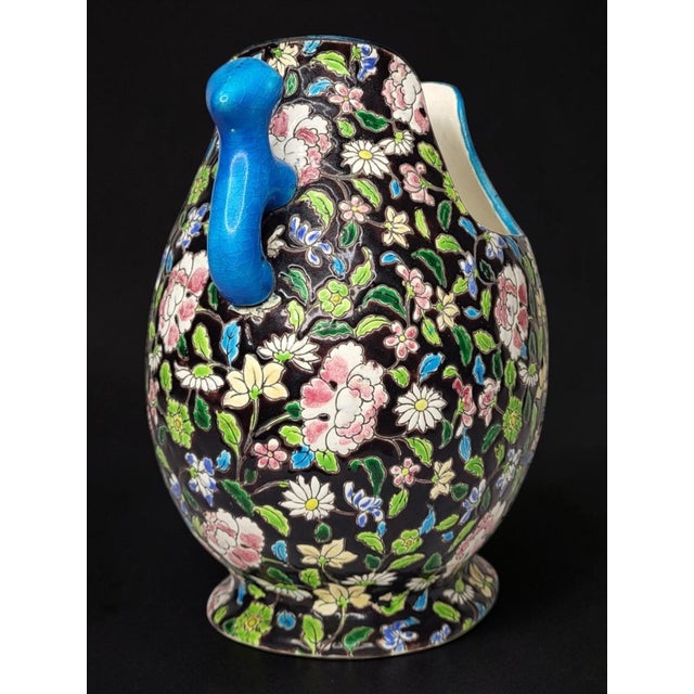 "Gueulard" vase in glazed ceramic from Gien / Handles in the shape of Foo dogs. Black background with floral decoration....