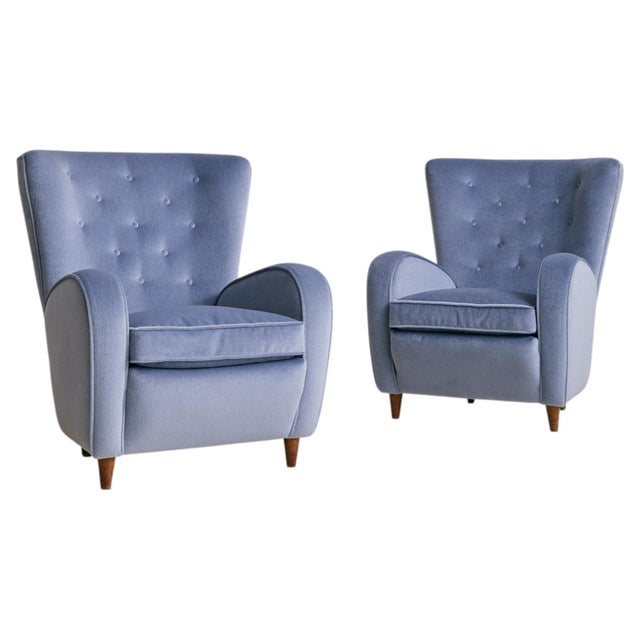 Sold and priced individually. A 1950s Italian lounge chair in the manner of Paolo Buffa. Reupholstered in cornflower blue...