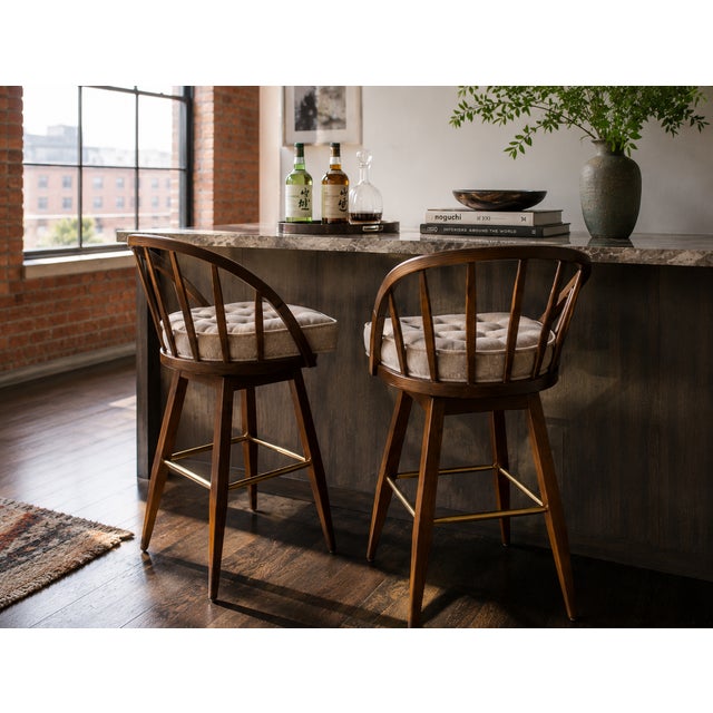 A striking pair of swivel bar stools by Edward Wormley for Dunbar Furniture, masterfully restored to highlight their...