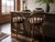 A striking pair of swivel bar stools by Edward Wormley for Dunbar Furniture, masterfully restored to highlight their...