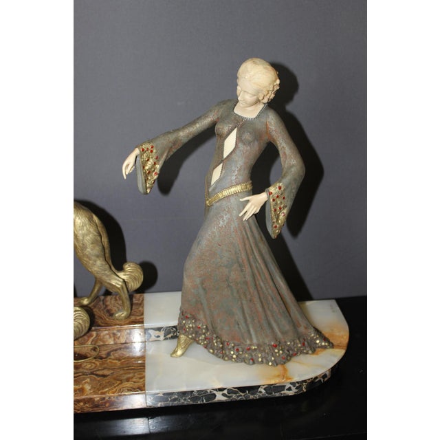 Important Chryselephantine sculpture in spelter and bakelite representing a woman with greyhounds on a Portor marble and...