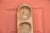 A long, primitive carved wooden dough bowl with heavily weathered patina and fitted with a series of eight round hollowed...