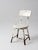A vintage child’s chair, circa 1930s–1950s, with a painted wood seat and back set on a simple metal frame. The form draws...