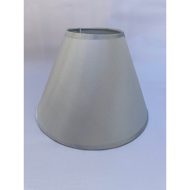 A single small empire shape lamp shade covered in a silver sage solid fabric. 10" base 6.5" height 10.5" slant 5.5" uno...