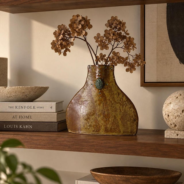 Beautiful modern studio pottery vase featuring an organic, free-form silhouette with a richly textured earthy brown and...