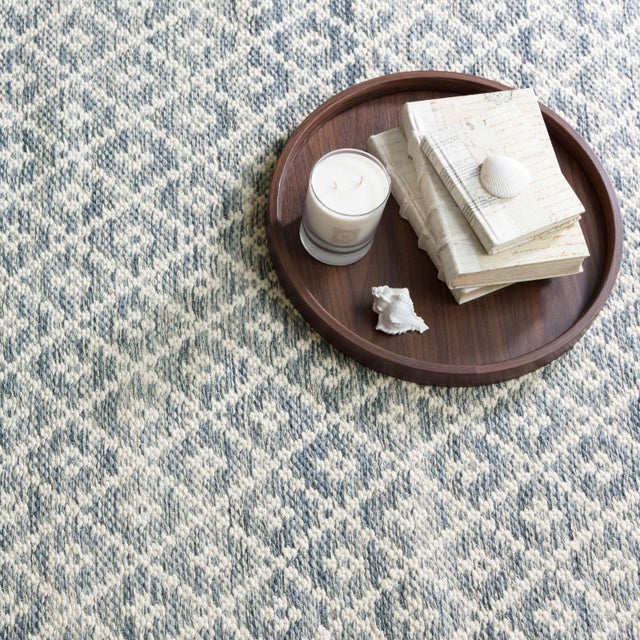 Lightweight, easygoing flatweave cotton rug with a classic diamond pattern made new with a faded melange of monochromatic...