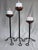 This is a striking set of three vintage Brutalist hand-forged metal candlesticks. Each holder has a warm copper...