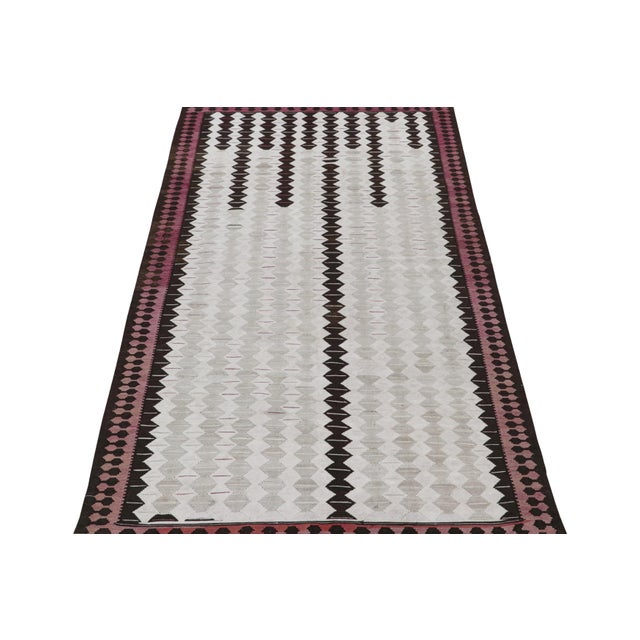 This vintage 6x10 Persian kilim is a rare mid-century Shahsavan rug, believed to originate from the city of Qazvin. On the...