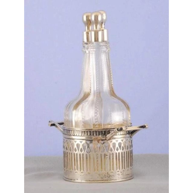 Antique German three bottle silver and crystal cruet set with 800 silver tops and original cut crystal bottles. The...