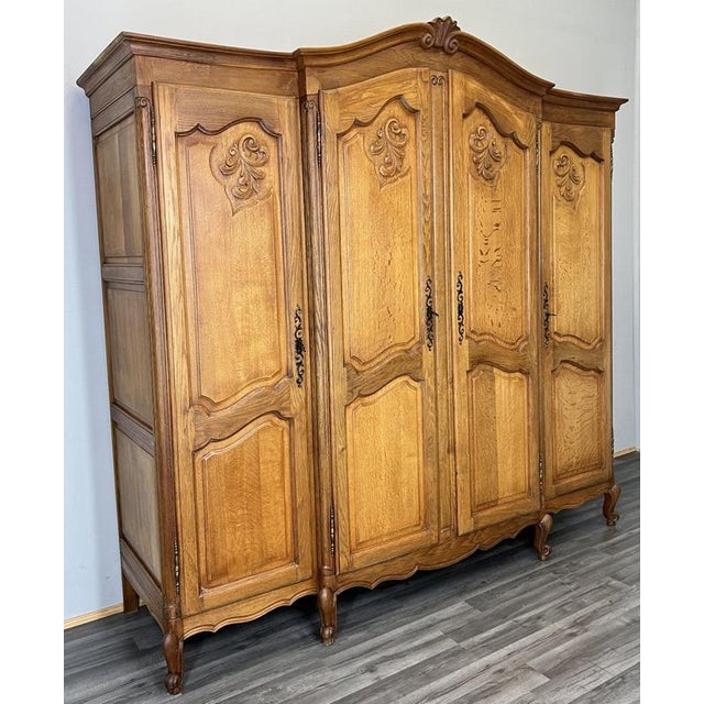 This elegant Vintage French Louis style wardrobe features beautifully carved panel doors, a gently arched cornice with...