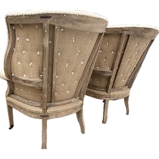 A Pair of Tufted Restoration Hardware Deconstructed Wingback Chairs They’re tall, substantial, and unapologetically...