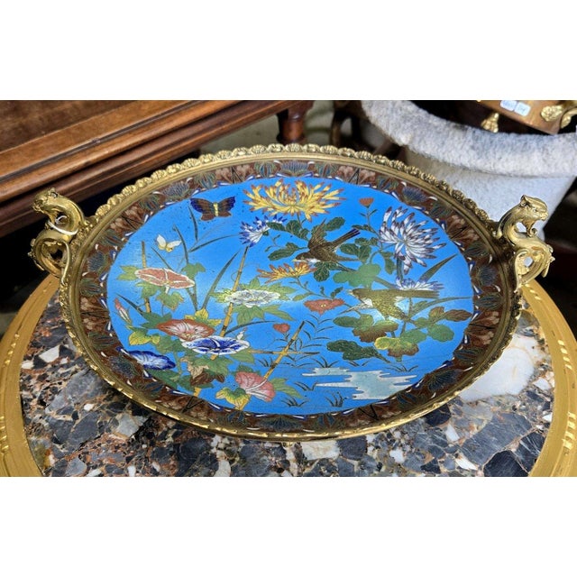 19th-century Asian cloisonné cup on a gilt bronze foot decorated with birds perched on branches and butterflies in a...