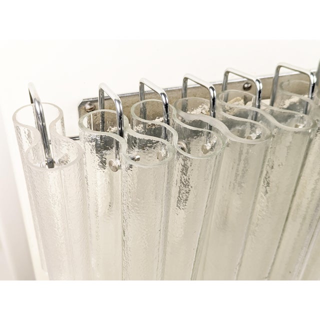 Large sconce made of chrome plated metal structure with 11 clear molded glass "canne" elements. Electrical system composed...