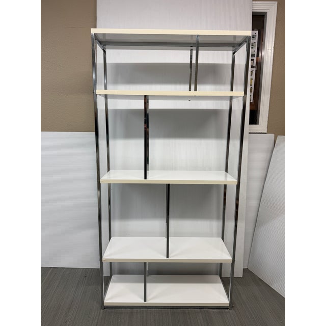Design Plus Gallery presents a Modern Etagere. Glossy white shelves are framed by chrome-toned metal, creating a geometric...