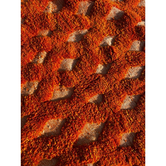 Make a bold statement with this stunning handmade Moroccan rug in vivid orange wool, designed to energize and transform...