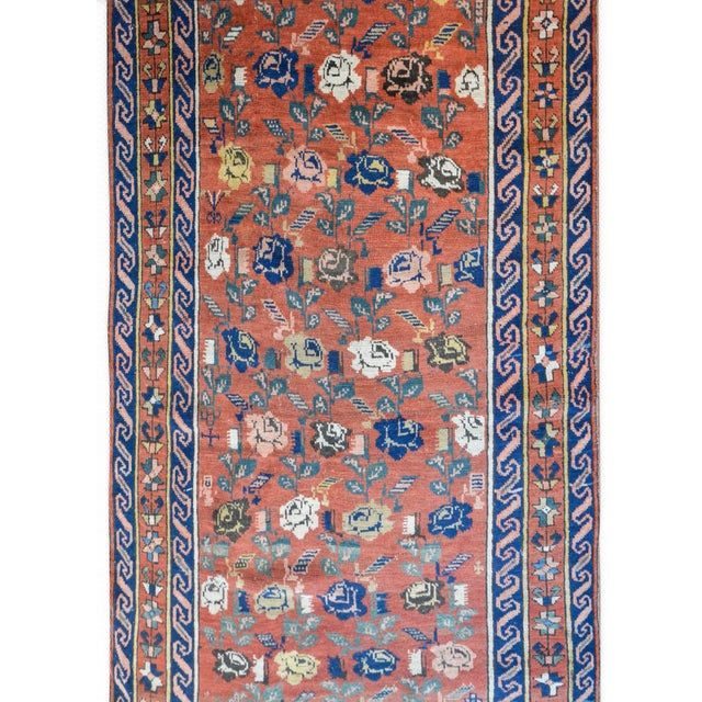 An extraordinary early 20th century Caucasian Karabagh rug with an all-over large scale rose pattern woven in white,...
