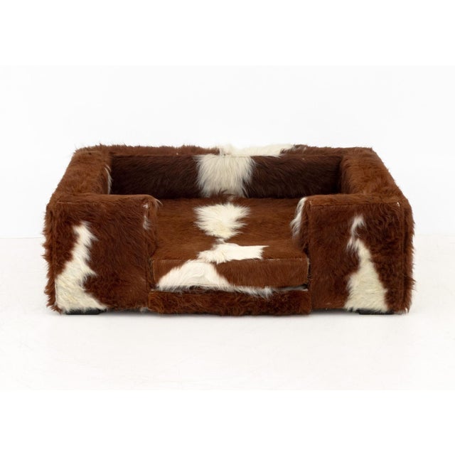 Cowhide Upholstered Dog Bed, brown and white long haired cowhide. 13.5" H x 40" W x 32" D. Provenance: From a Forest Hills...