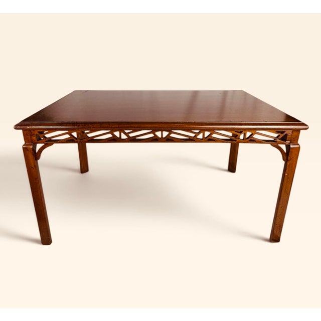 This is a vintage Chinese Chippendale-style rectangular wood table featuring an open geometric fretwork apron on all four...
