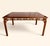 This is a vintage Chinese Chippendale-style rectangular wood table featuring an open geometric fretwork apron on all four...